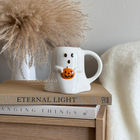 Speckled ceramic mug with ghost and pumpkin design