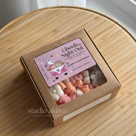 Box of 'Ghouls Night Out' wax melts with a pink label on a wooden surface.
