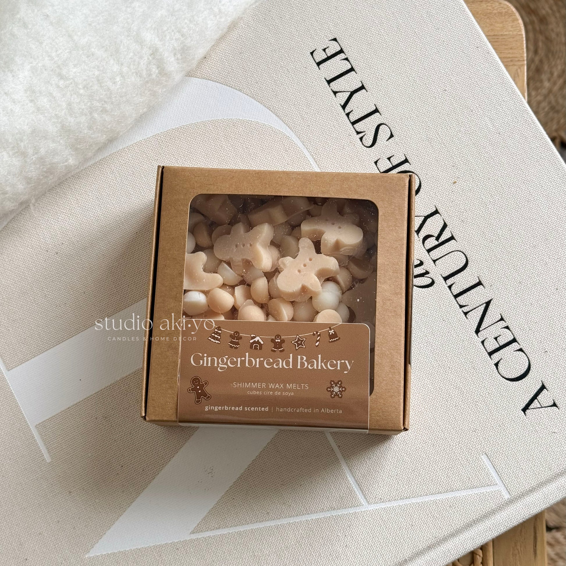 Box of gingerbread-themed wax melts on a magazine with 'studio aloha' branding.