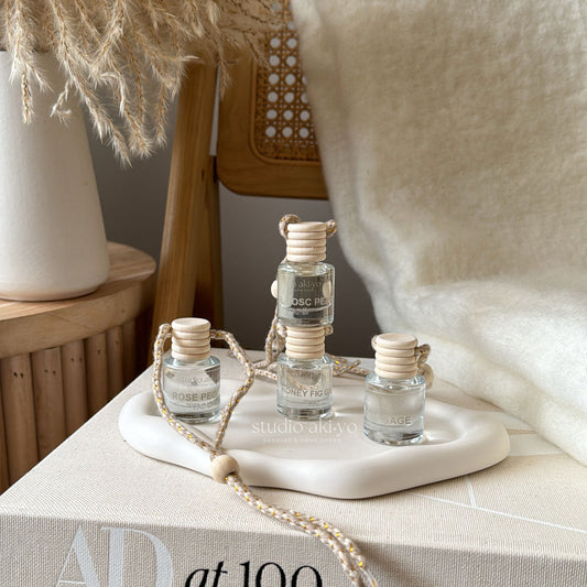 Neutral aesthetic hanging car diffusers by Studio Akiyo.