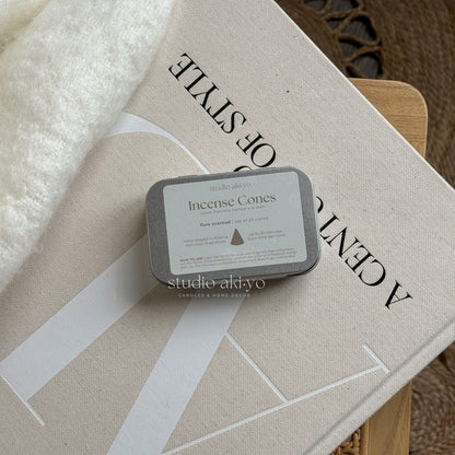 Metal tins with hand dipped incense cones called Flow