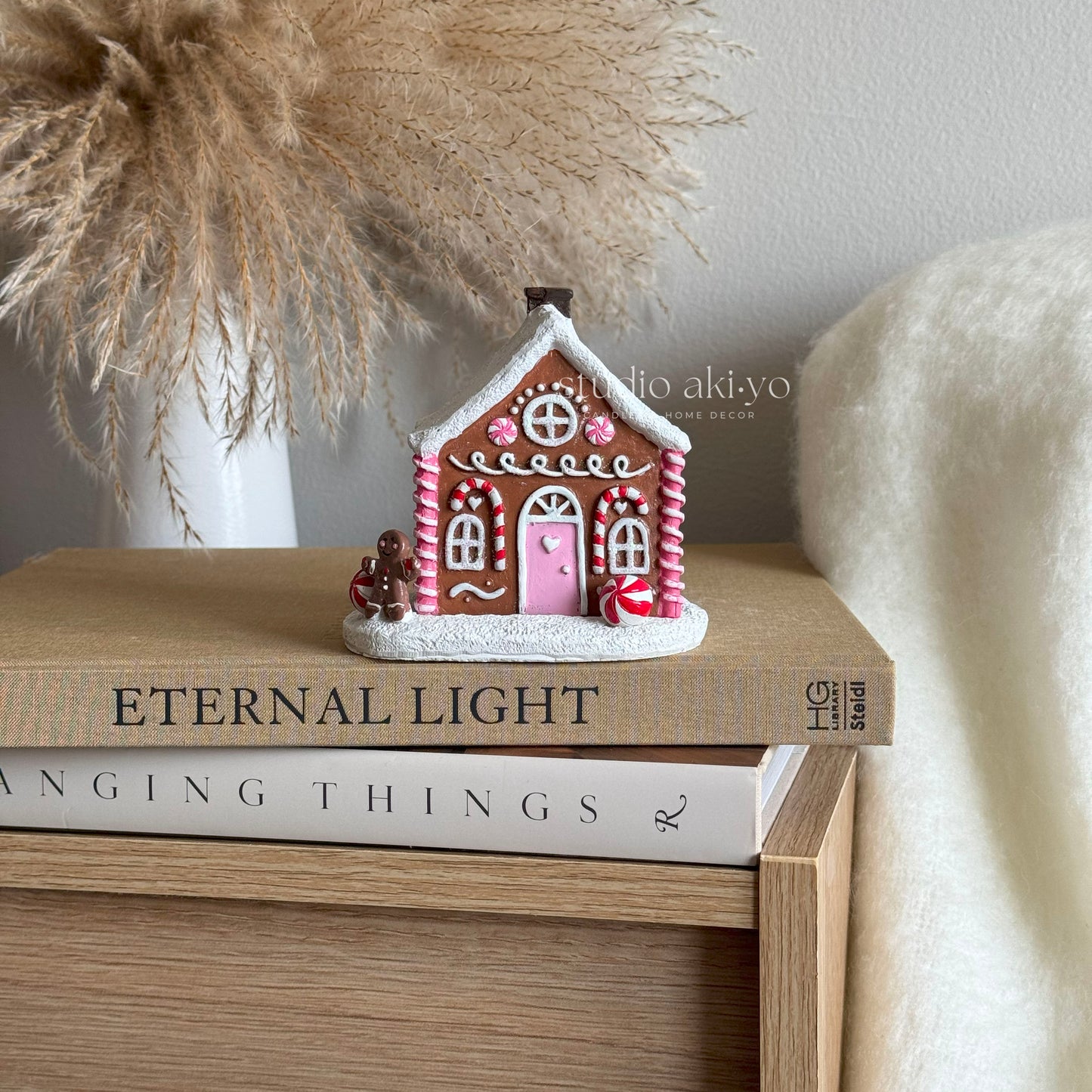 Pink Gingerbread Incense Cone Holder on books with a neutral background