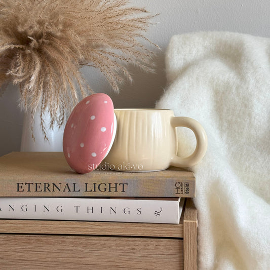 Pink polka dot egg on a beige mug with books and decorative elements