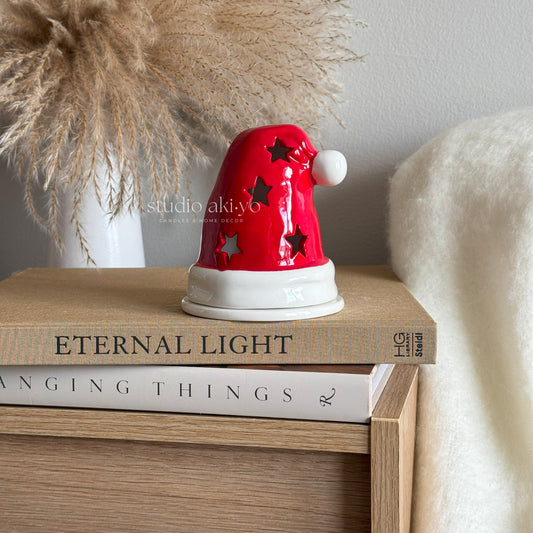 Fragrance the home this Christmas with this festive candle holder shaped like Santa's iconic red hat that doubles as an incense cone burner. 