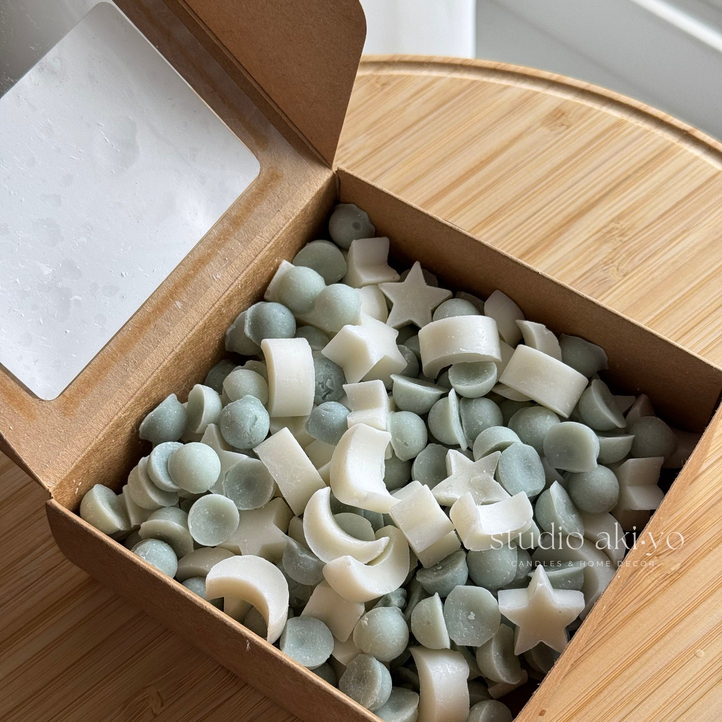 Box of assorted silicone mold shapes on a wooden surface
