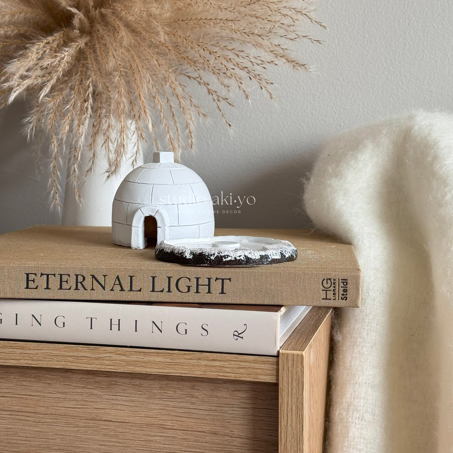 Igloo Incense Cone Holder on books with decorative elements in the background