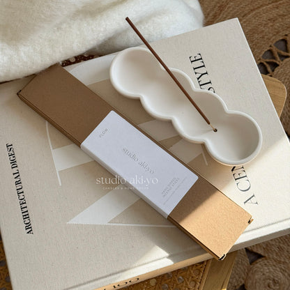 Incense stick holder with incense sticks Flow from Studio Akiyo.