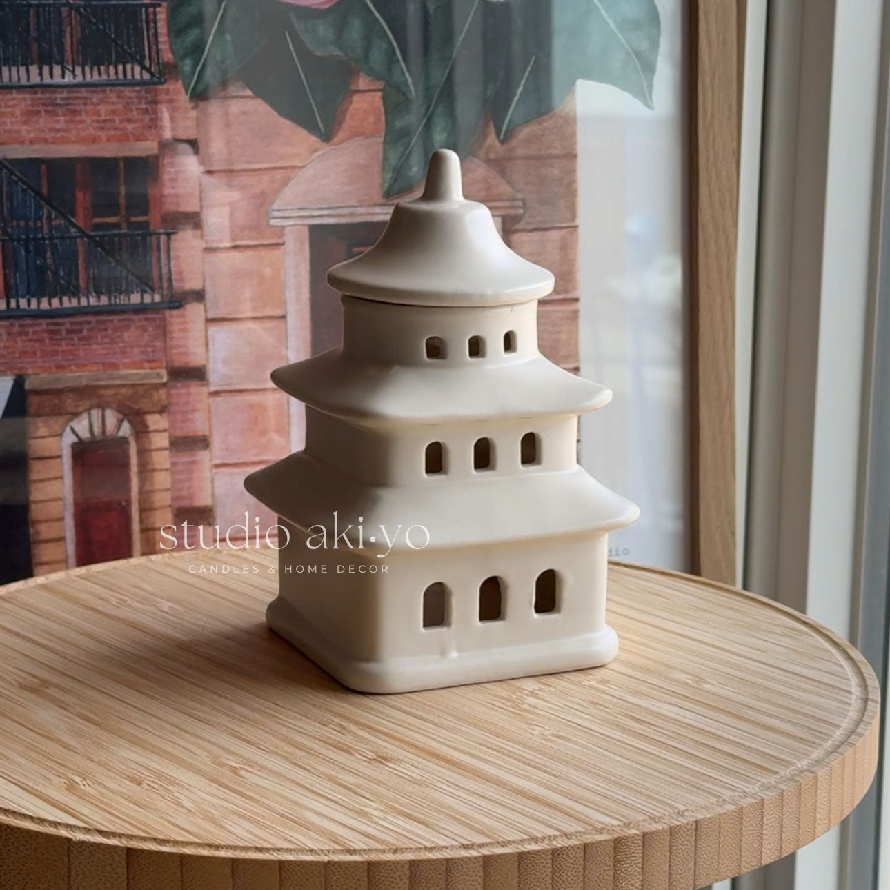 Ceramic pagoda-shaped vase on a wooden table with a blurred background