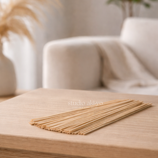 Natural reed sticks for reed diffusers on a wooden surface with a blurred background