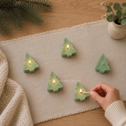 Hand lighting Studio Akiyo winter wonderland green tree tealight scented candles.