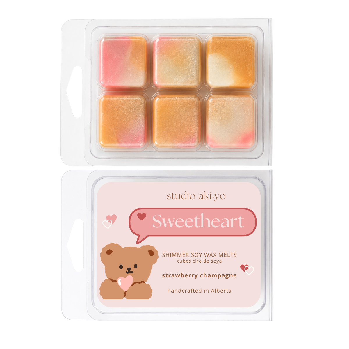 Two packages of Studio Akiyo 'Sweetheart' strawberry champagne shimmer soy wax melts. The top package shows six individual wax cubes with a pink, orange, and yellow marbled pattern inside a clear plastic clamshell.