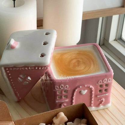 Pink ceramic gingerbread house wax melt burner, perfect for the holiday season.