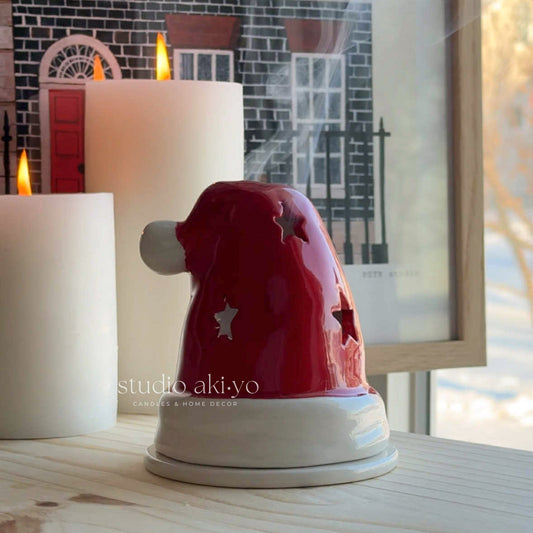Ceramic incense cone holder in shape on red Santa's hat by Studio Akiyo.
