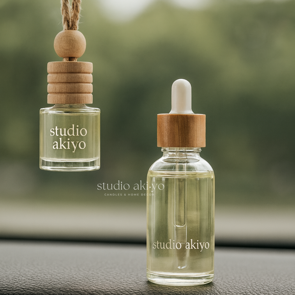 Two 'studio akiyo' products, a hanging diffuser and a dropper bottle, on a blurred green background.